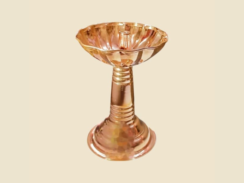Copper Samai Deepak on a warm ivory background