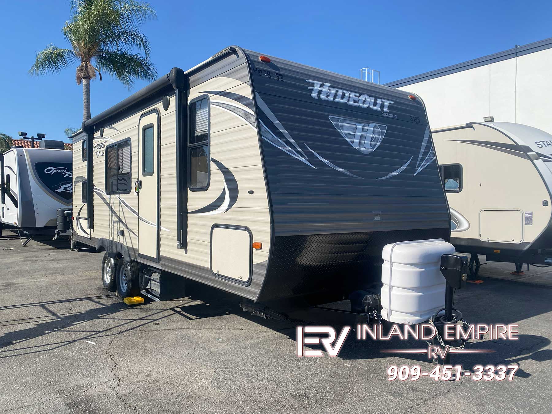 Exterior front and passenger side view of a 2018 Keystone Hideout 21LHSWE Travel Trailer RV
