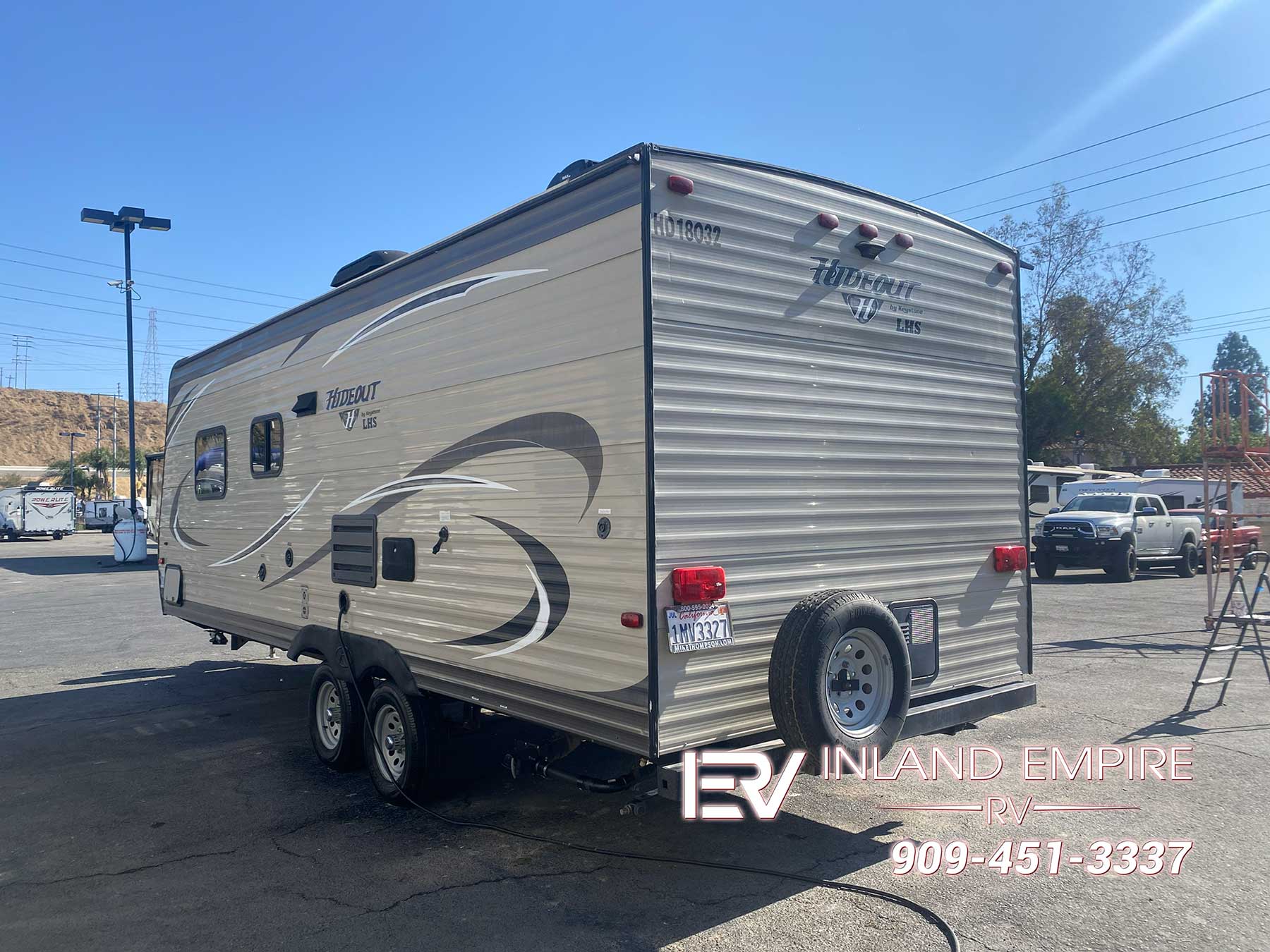 Exterior rear and drivers side view of a 2018 Keystone Hideout 21LHSWE Travel Trailer RV
