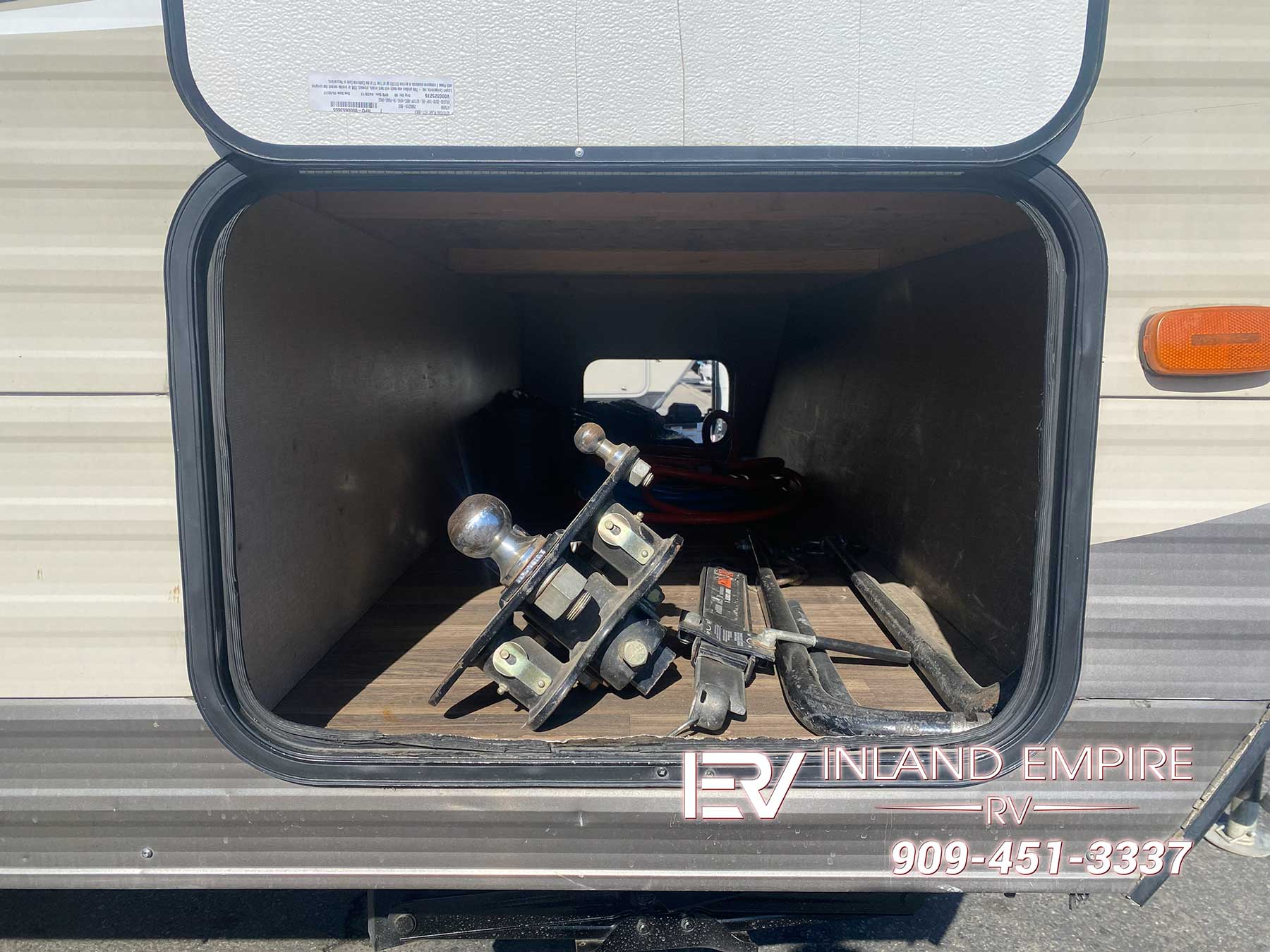 Pass through storage compartment on the passenger side