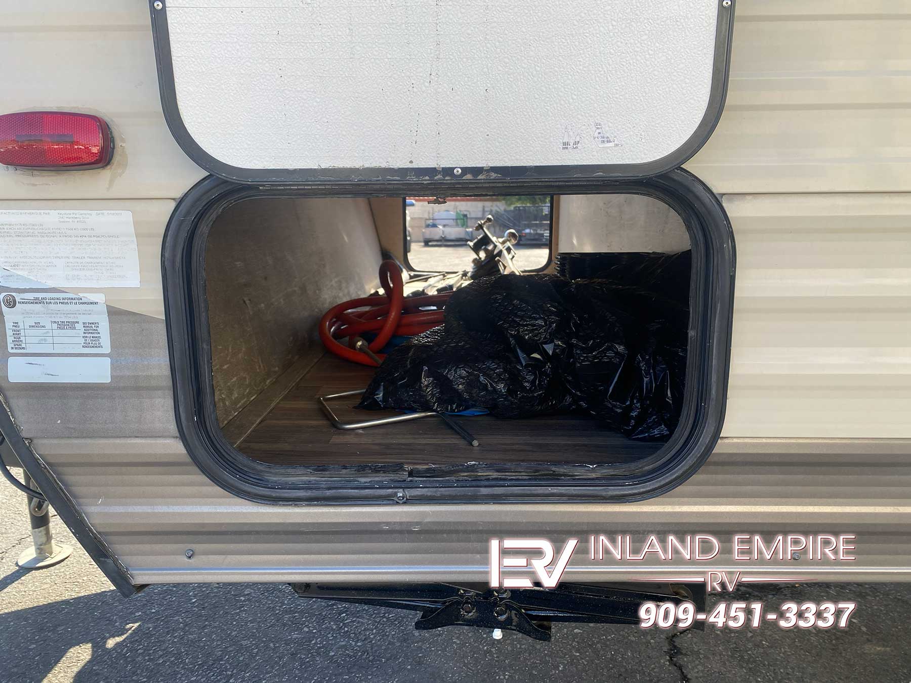 Pass through storage compartment on the drivers side