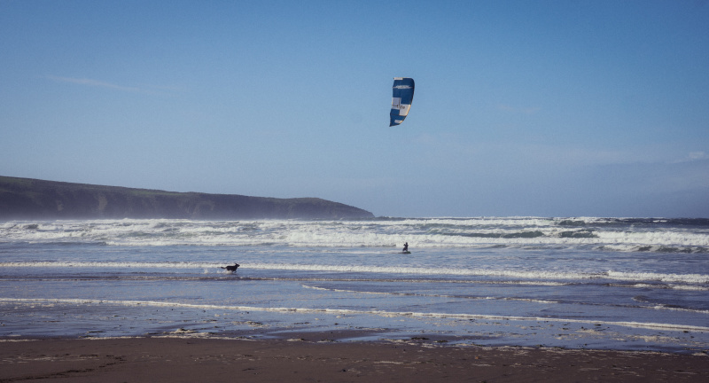 Kite surfing with dog in chase