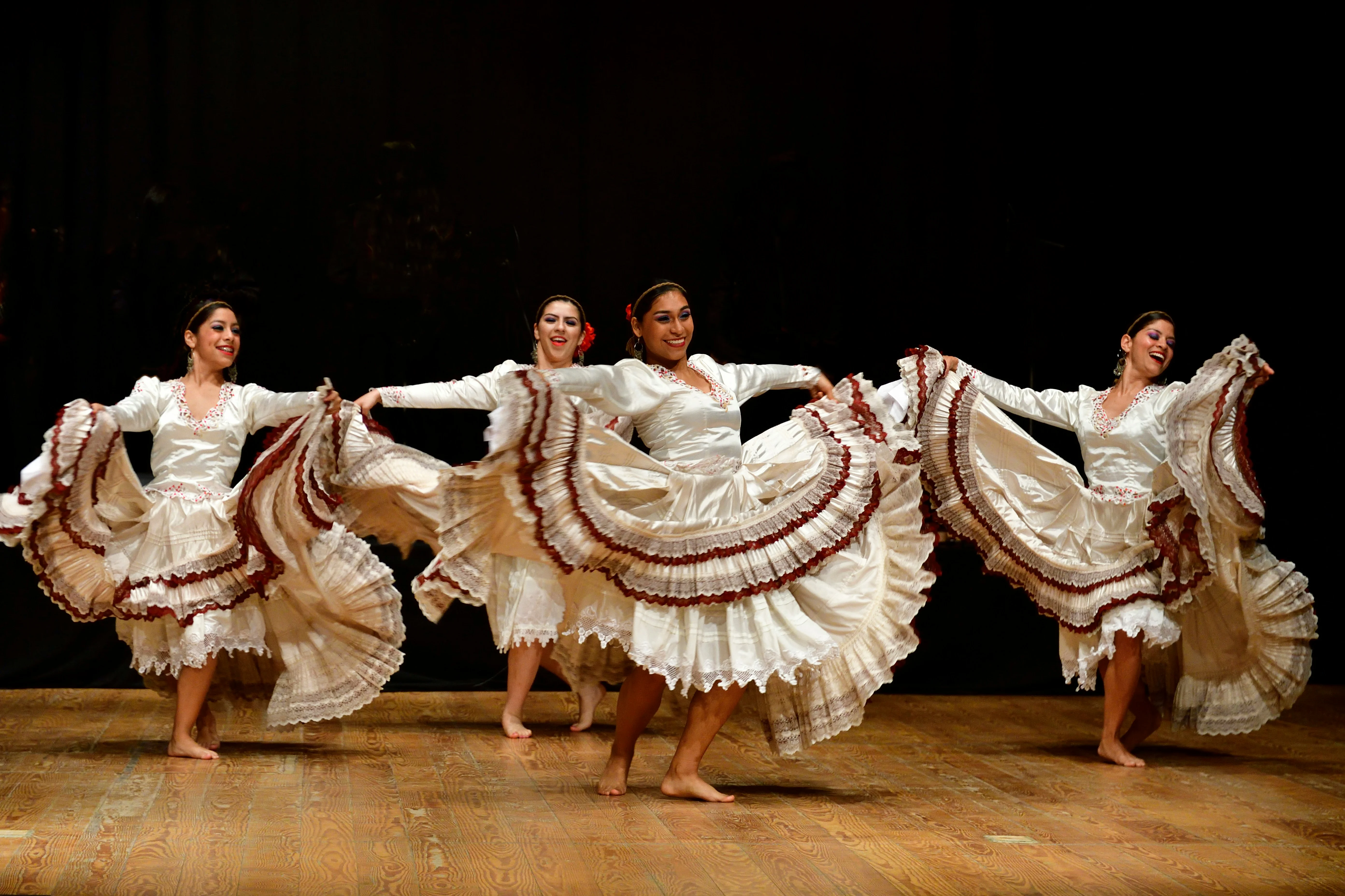 Four women barefooted dancing on stage