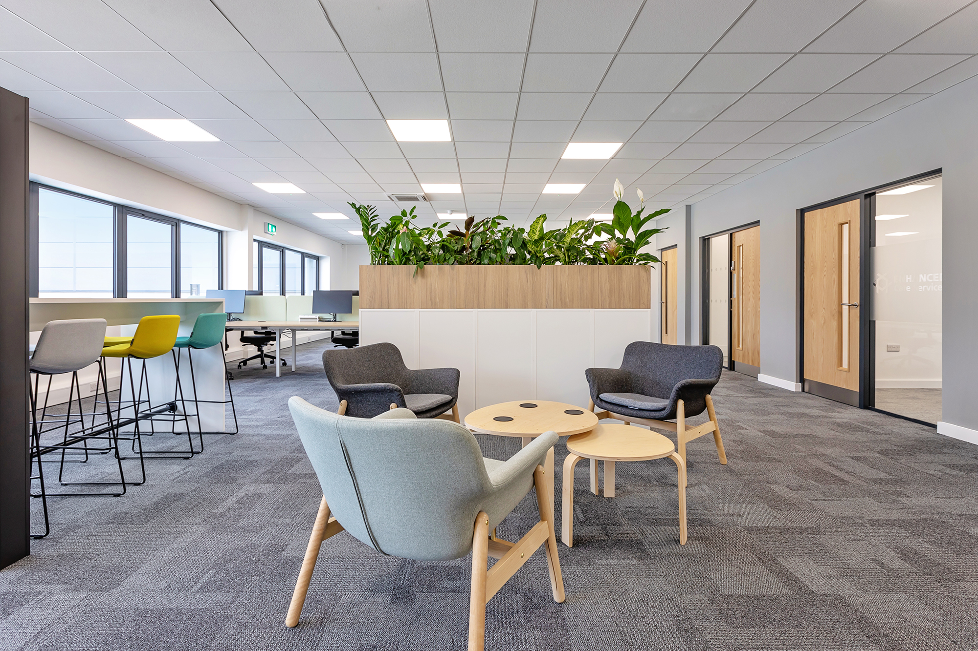 modern office breakout area with variable height chairs in a variety of colours.