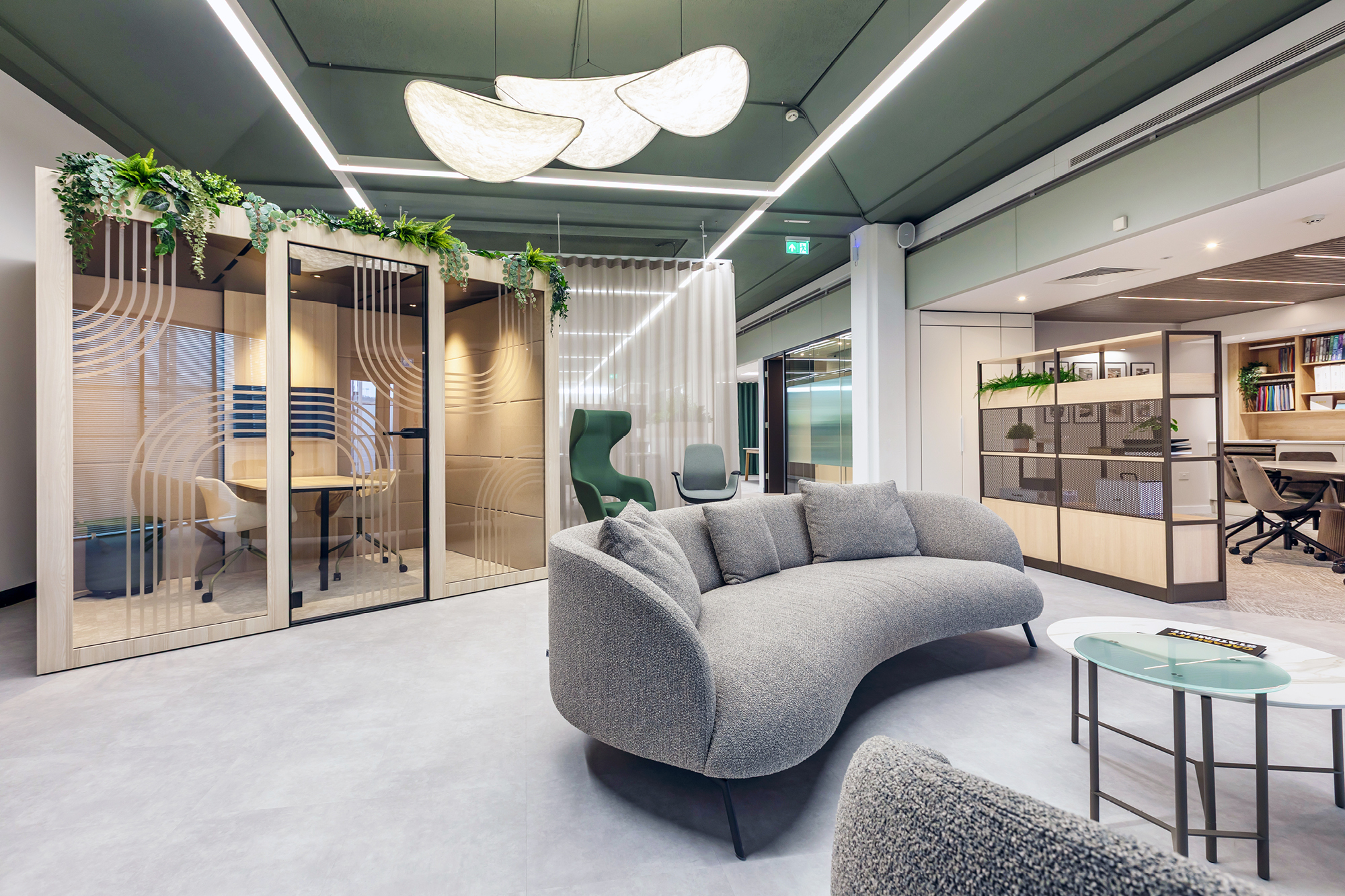 Modern office space with a meeting pod and acoustic lighting panels