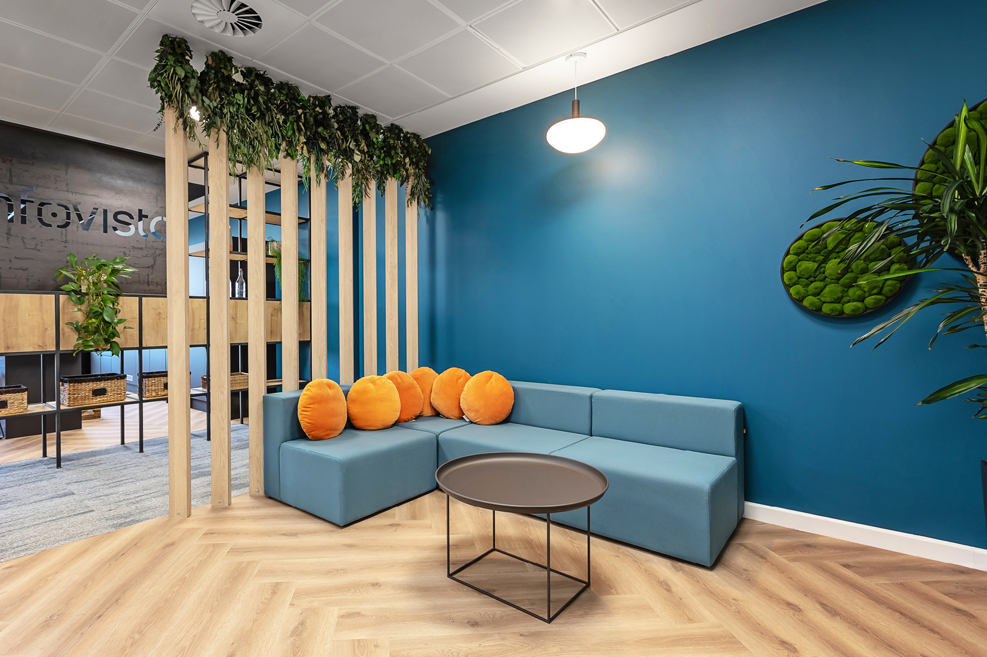 Spacious, empty office space with carpeted floors and multiple tables