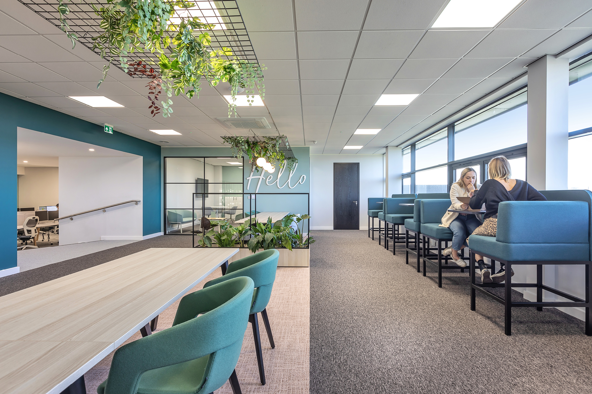 Office Boardroom with white and green walls, including table and green chairs