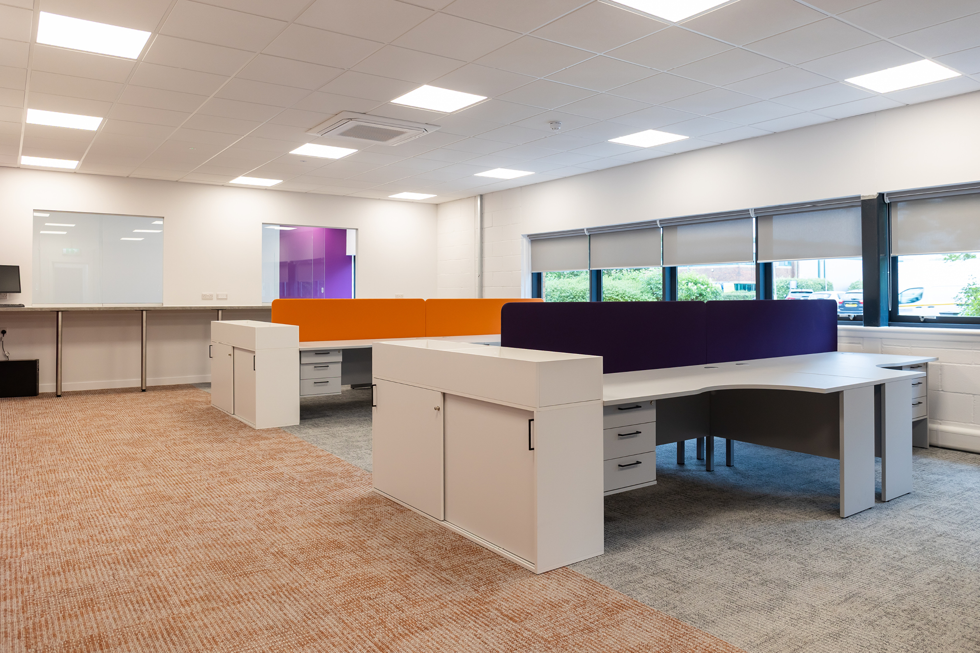 office space area with lockers, purple and orange desk separators
