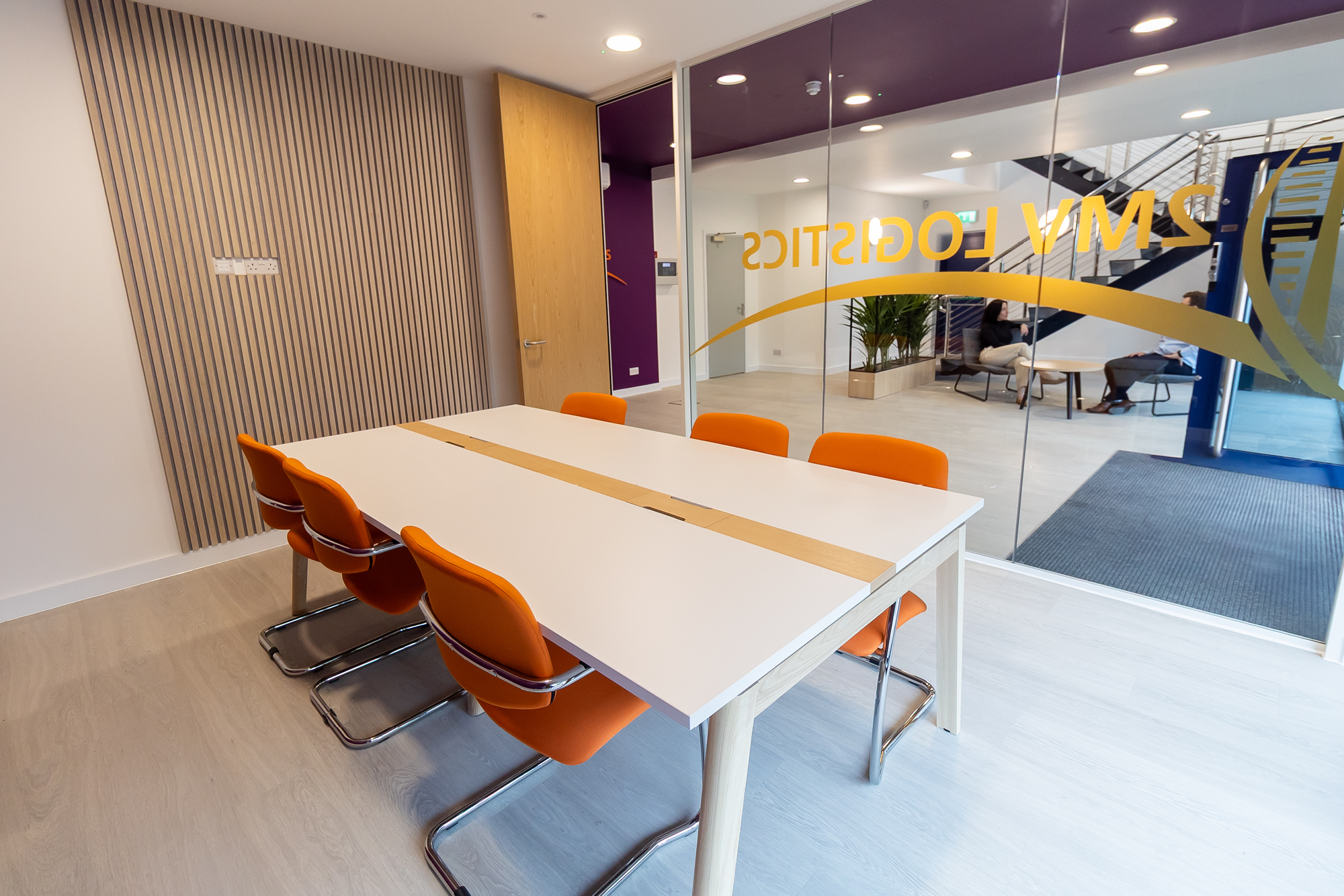 office boardroom with orange chairs and acoustic panelling
