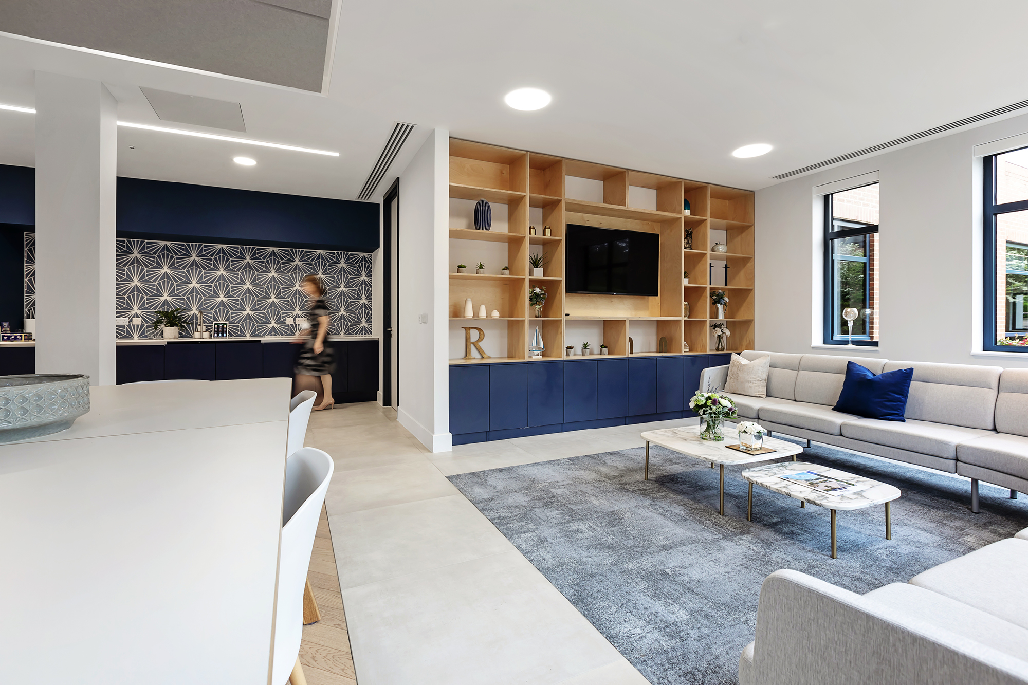 executive lounge with tv and white sofa seating