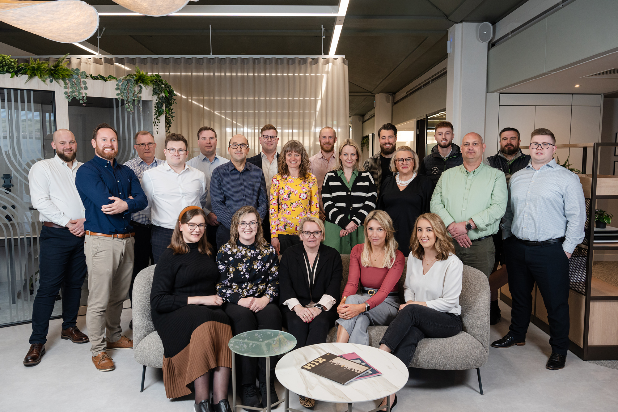 a group of people sitting and standing