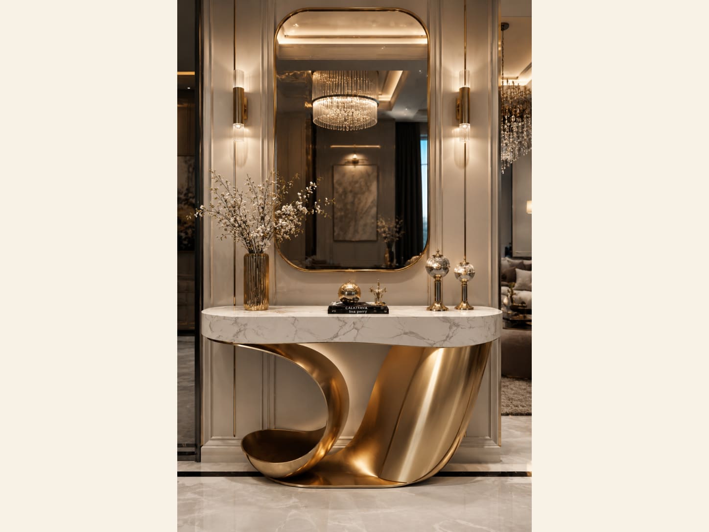 A Sculptural Swirled-Gold Console with a Marble Top A statement entryway with a sculptural swirled-gold console base, a white marble top, a rounded gold mirror, slim gold wall sconces, white blossom branches and a round chandelier reflected in the glass.