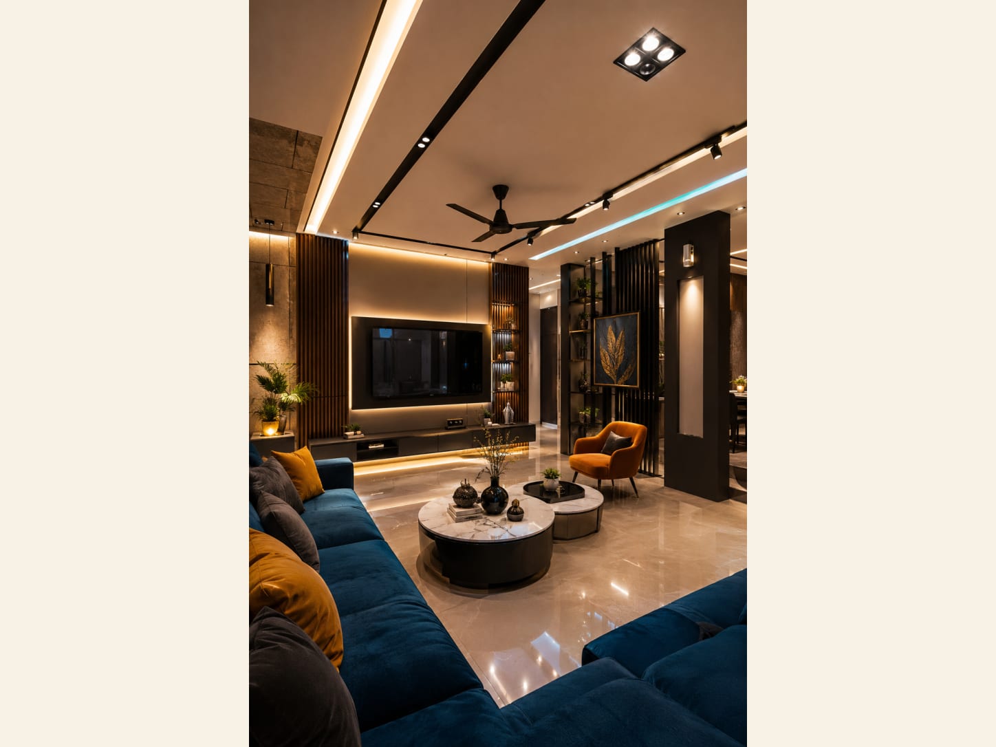 A deep navy velvet sectional, mustard accents and layered cove lighting turn this open living room into a warm, hotel-lounge kind of evening.