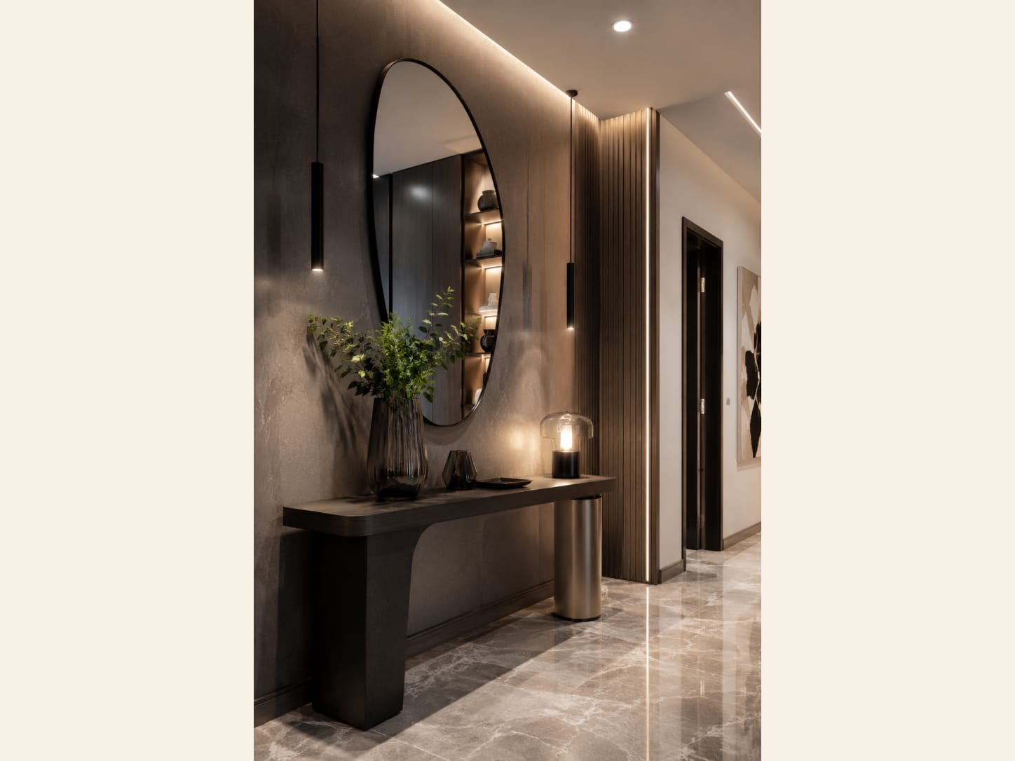 Build a moody entrance around stone, shadow and an organic mirror Moody luxury entryway with an organic mirror, dark console, softly lit stone wall and greenery