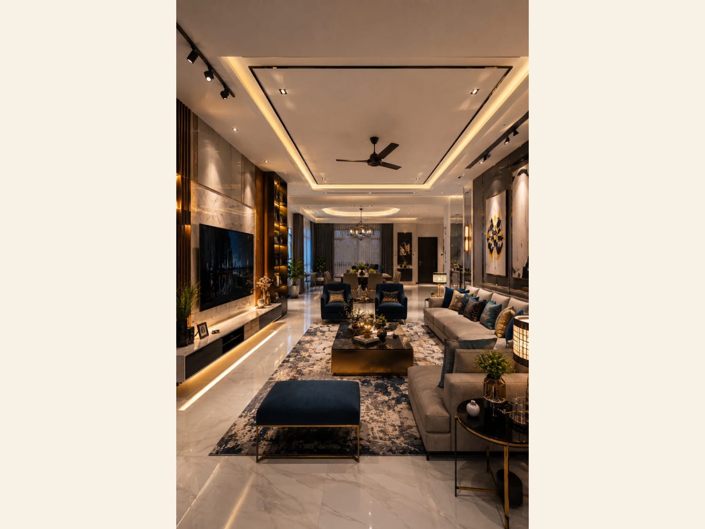 A Grand Open-Plan Living Room Wrapped in Marble and Gold A marble TV wall, gray sectional, navy accents and brass details make this open-plan living and dining space feel like a five-star suite.