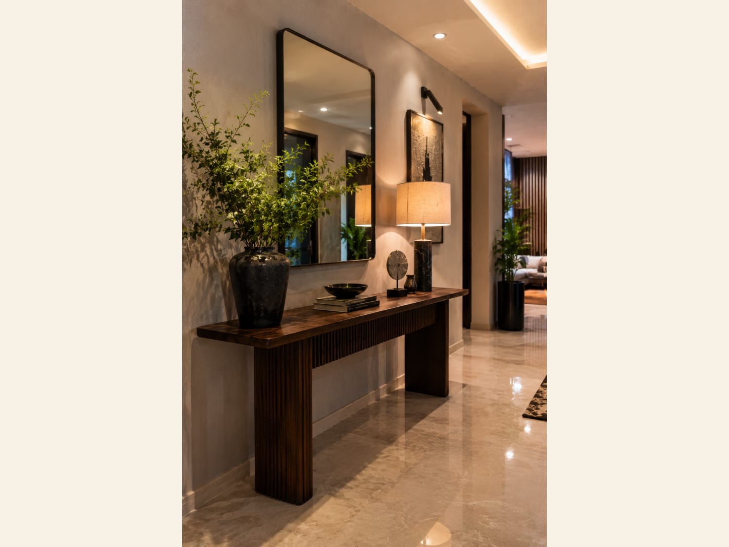 A Warm Minimal Entryway with a Fluted Wood Console A ribbed wood console, a big black-framed mirror and a soft lamp glow make this hallway feel warm, grounded and quietly luxe.