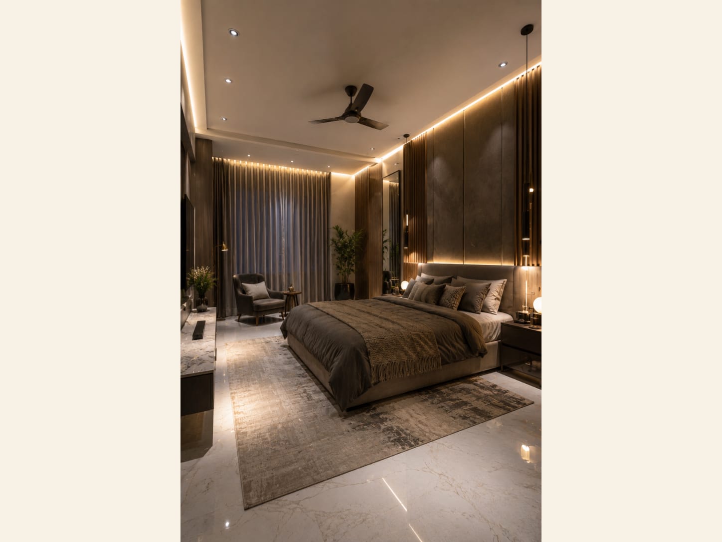 A moody, hotel-style master bedroom in warm taupe and bronze, wrapped in cove lighting and a fluted wood feature wall.
