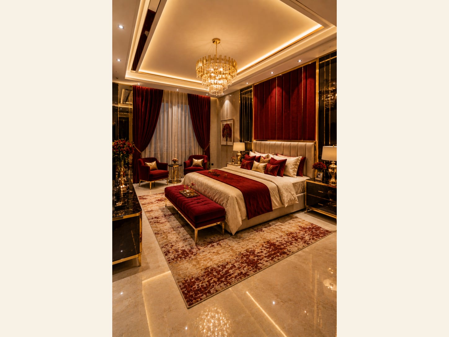 A Red and Gold Luxury Master Bedroom With a Velvet Feature Wall A cream tufted bed framed by a fluted red velvet wall, brass accents and a crystal chandelier, this master bedroom is pure warm-toned drama.