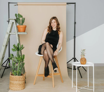 sheertex ceo katherine homuth sitting in a black chair, wearing black sheertex tights