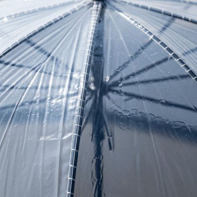 A close-up macro photograph focusing on the texture and pattern of the canopy fabric of a Bubble Umbrella (umbrellas)