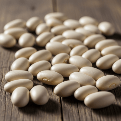 A handful of uncooked Cannellini Bean beans (beans) scattered on a rustic wooden surface, photographed in natural light to emphasize their variety and color