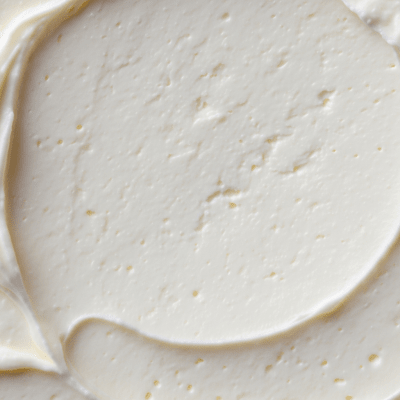 A close-up macro photograph of the rind and surface texture of a Cream Cheese