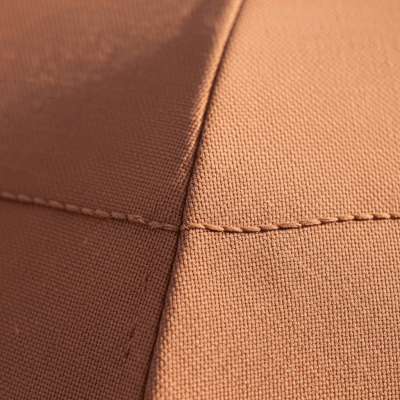 A close-up macro photograph focusing on the texture and pattern of the canopy fabric of a Dual-purpose Umbrella (umbrellas)