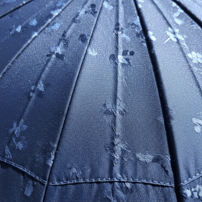 A close-up macro photograph focusing on the texture and pattern of the canopy fabric of a Folding Umbrella (umbrellas)