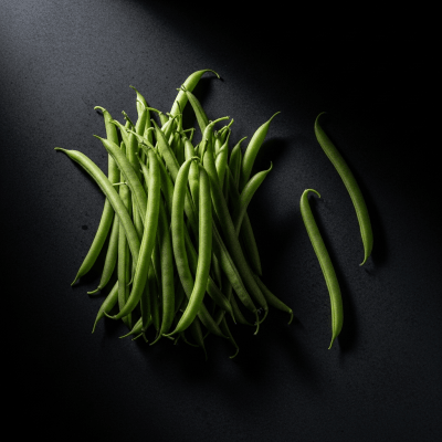 Editorial-style photograph of French Bean, part of the taxonomy beans, arranged aesthetically on a dark background with dramatic lighting to highlight its shape and color.