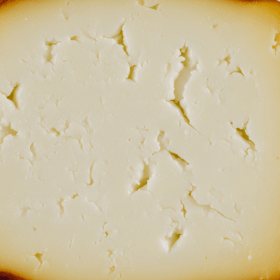 A close-up macro photograph of the rind and surface texture of a Halloumi