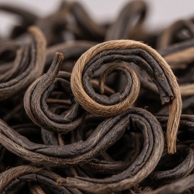 Macro photograph focusing on the texture and details of Keemun Tea leaves, within the taxonomy teas