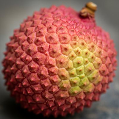 Macro shot capturing the surface texture and color details of the Lychee, within the fruits taxonomy