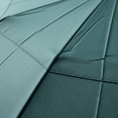 A close-up macro photograph focusing on the texture and pattern of the canopy fabric of a Manual Folding Umbrella (umbrellas)