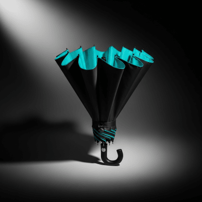 Editorial-style hero shot of a single Reverse Folding Umbrella (umbrellas) dramatically lit against a dark gradient background.