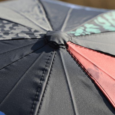 A close-up macro photograph focusing on the texture and pattern of the canopy fabric of a Reverse Folding Umbrella (umbrellas)