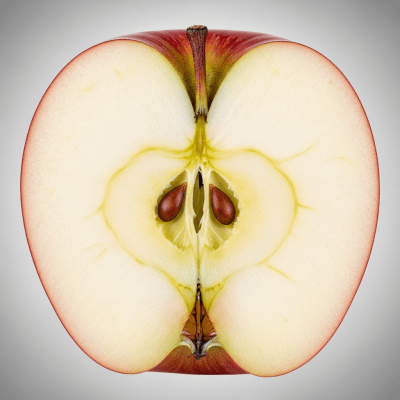 A close-up image showing a cross-section of a Spartan of the taxonomy apples, sliced cleanly in half to reveal internal structure, seeds, and flesh