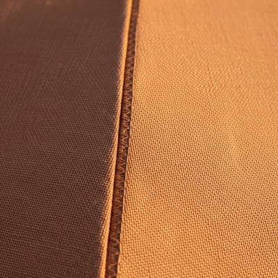 A close-up macro photograph focusing on the texture and pattern of the canopy fabric of a Sun Umbrella (umbrellas)