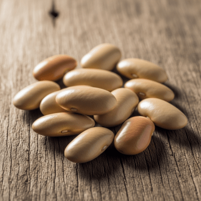 A handful of uncooked Sword Bean beans (beans) scattered on a rustic wooden surface, photographed in natural light to emphasize their variety and color