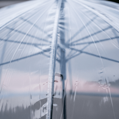 A close-up macro photograph focusing on the texture and pattern of the canopy fabric of a Transparent Umbrella (umbrellas)