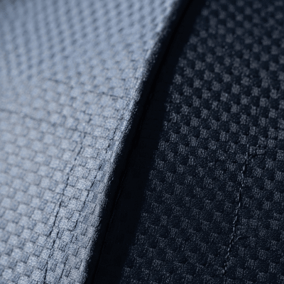 A close-up macro photograph focusing on the texture and pattern of the canopy fabric of a Travel Umbrella (umbrellas)