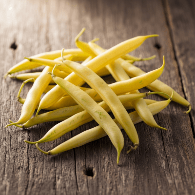 A handful of uncooked Wax Bean beans (beans) scattered on a rustic wooden surface, photographed in natural light to emphasize their variety and color