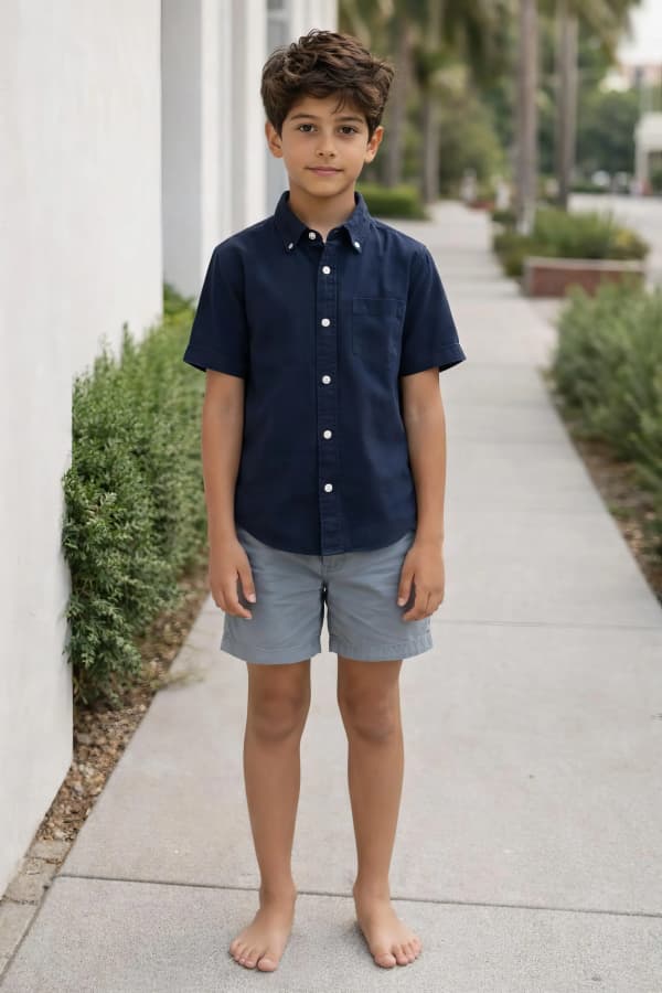 Boy standing on sidewalk