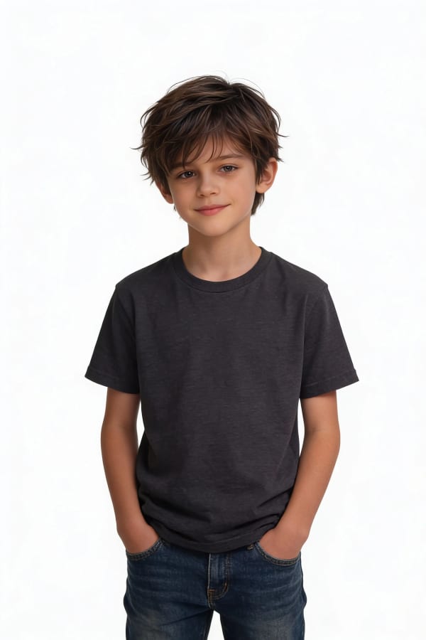 Boy standing against plain background