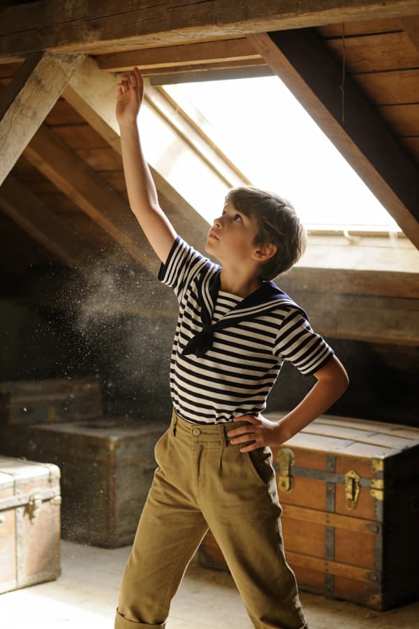 Boy exploring dusty attic