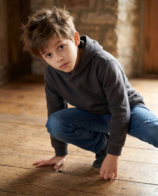 Boy crouching indoors