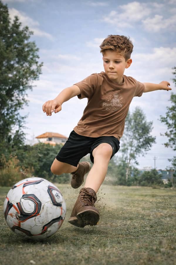 Boy kicking soccer ball