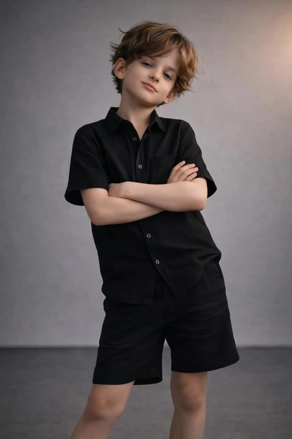 Boy in black shirt standing