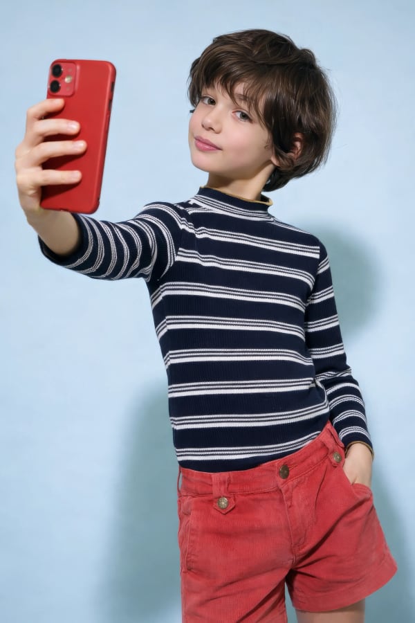 Boy taking selfie with red phone