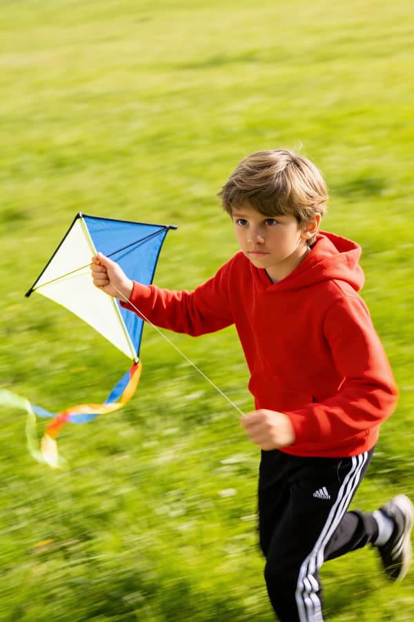 Boy running with kite