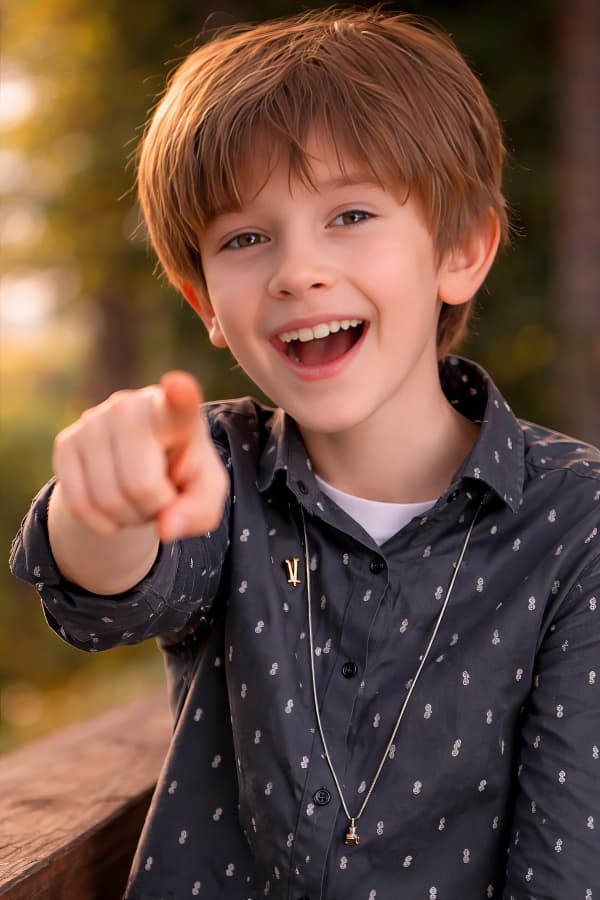 Boy Pointing Both Fingers Pose In Studio